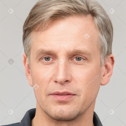 Joyful white adult male with short  brown hair and grey eyes