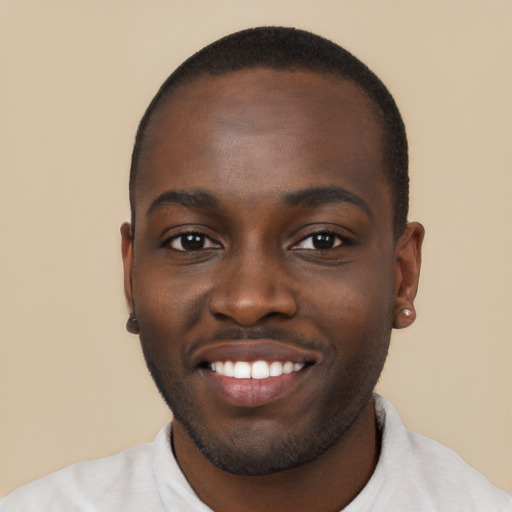 Joyful black young-adult male with short  brown hair and brown eyes