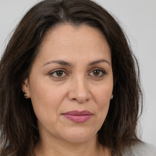 Joyful white adult female with medium  brown hair and brown eyes