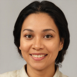 Joyful white adult female with medium  brown hair and brown eyes