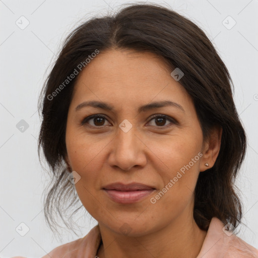 Joyful latino adult female with medium  brown hair and brown eyes