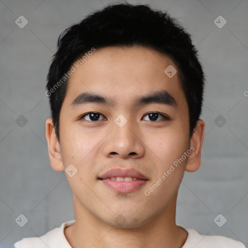 Joyful asian young-adult male with short  black hair and brown eyes