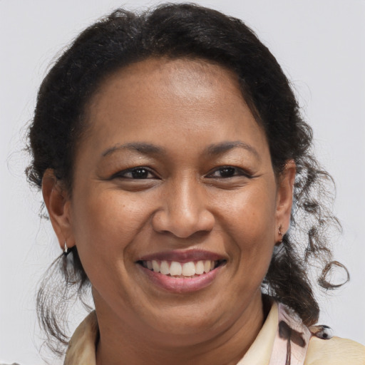 Joyful latino adult female with medium  brown hair and brown eyes