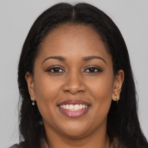Joyful latino young-adult female with long  brown hair and brown eyes