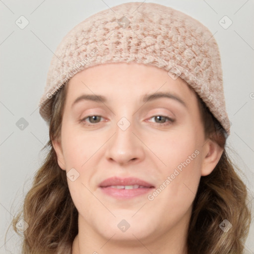 Joyful white young-adult female with long  brown hair and blue eyes