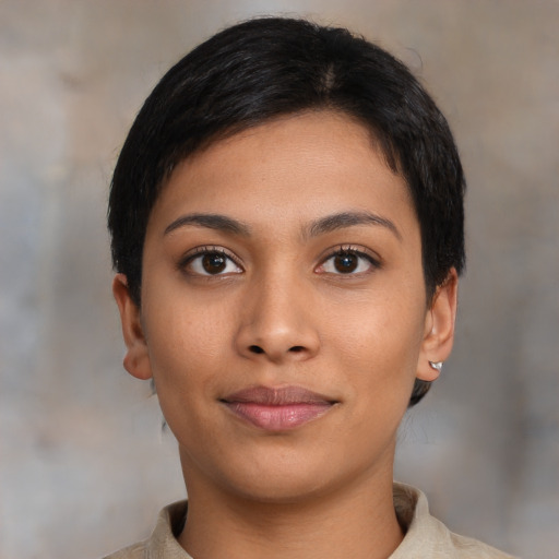 Joyful latino young-adult female with short  black hair and brown eyes