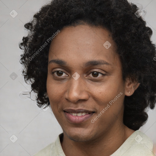 Joyful black young-adult female with long  black hair and brown eyes