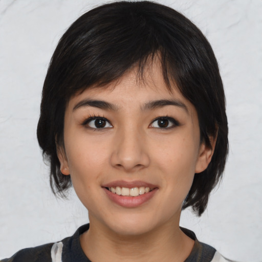 Joyful asian young-adult female with medium  black hair and brown eyes