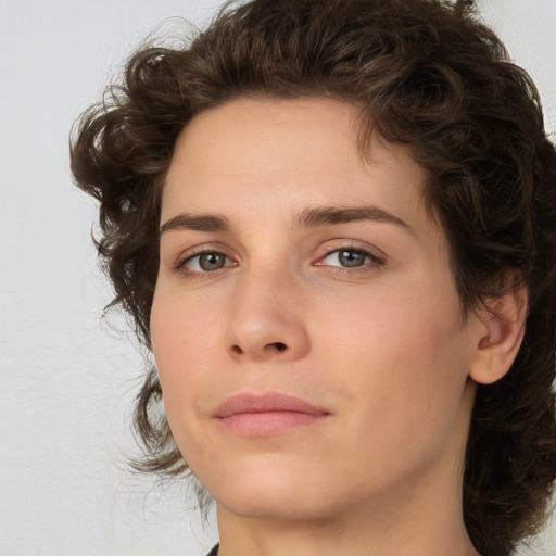 Joyful white young-adult female with medium  brown hair and green eyes