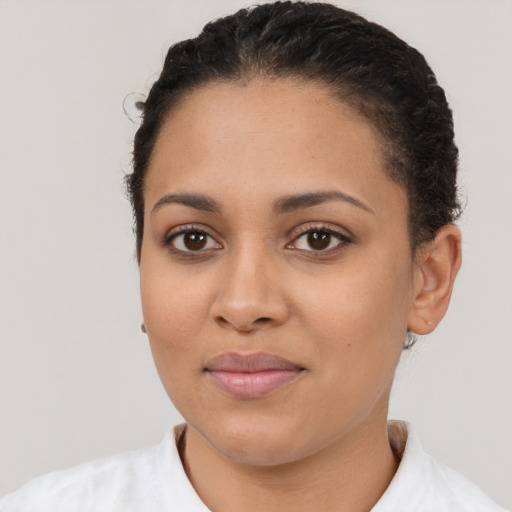 Joyful latino young-adult female with short  brown hair and brown eyes
