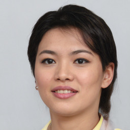 Joyful asian young-adult female with medium  brown hair and brown eyes