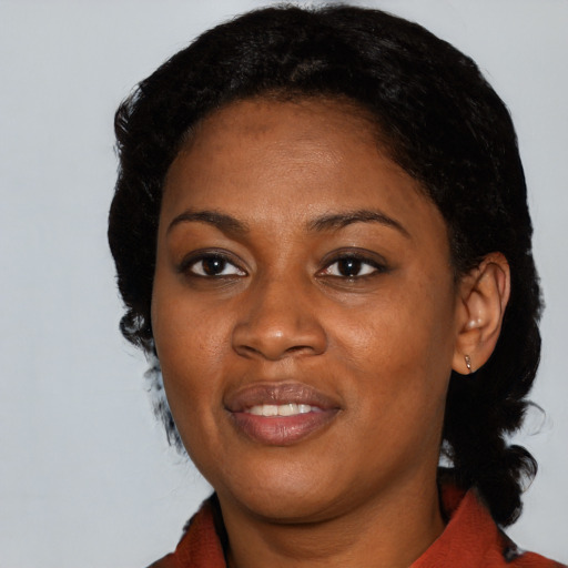 Joyful black young-adult female with medium  black hair and brown eyes
