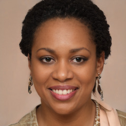 Joyful black young-adult female with long  brown hair and brown eyes