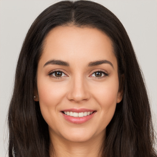 Joyful white young-adult female with long  brown hair and brown eyes