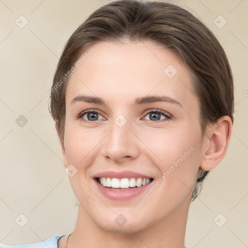 Joyful white young-adult female with short  brown hair and grey eyes