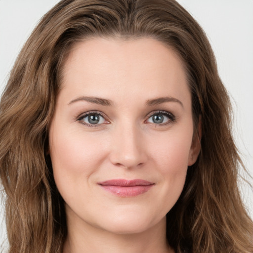 Joyful white young-adult female with long  brown hair and green eyes