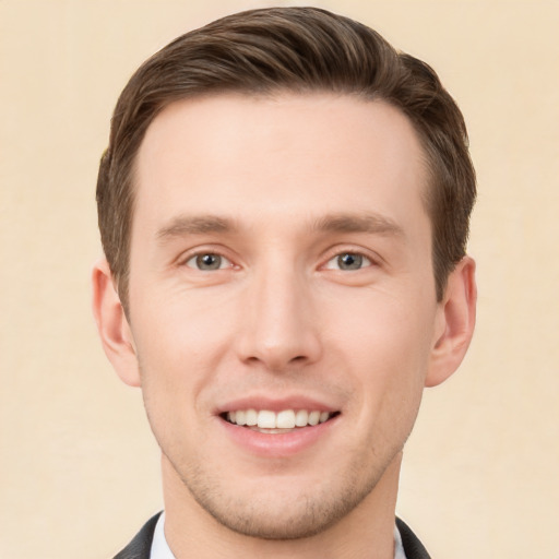 Joyful white young-adult male with short  brown hair and grey eyes