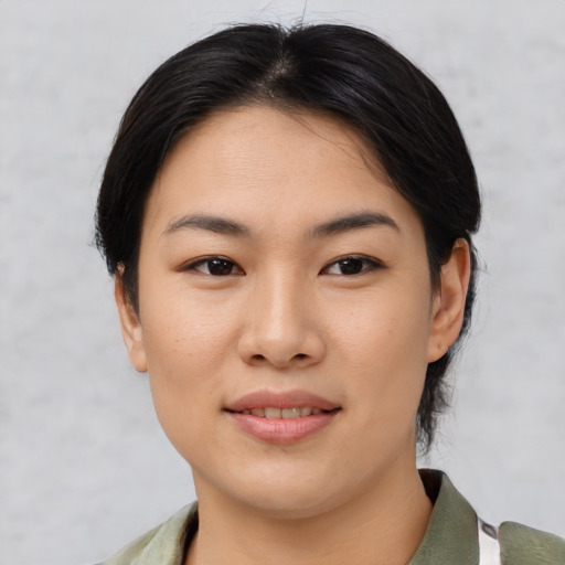 Joyful asian young-adult female with medium  brown hair and brown eyes