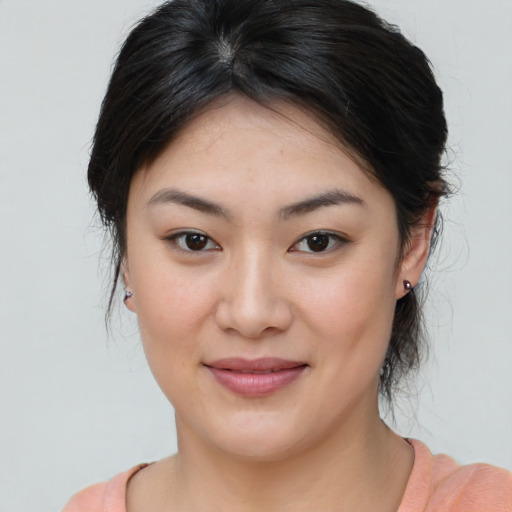 Joyful asian young-adult female with medium  brown hair and brown eyes
