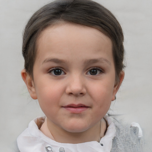 Joyful white child female with short  brown hair and blue eyes