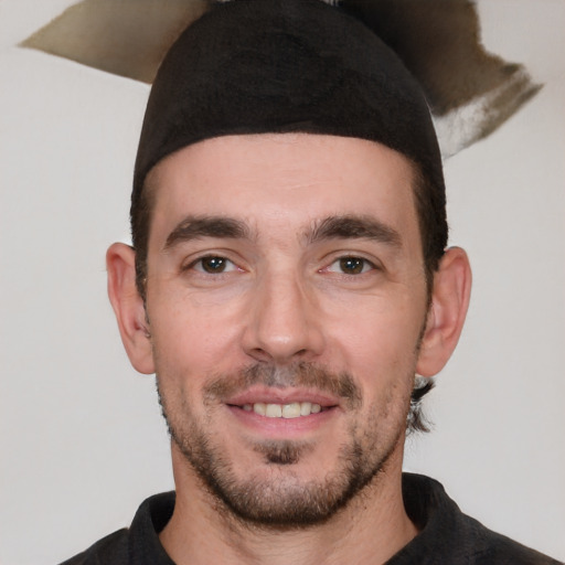 Joyful white young-adult male with short  black hair and brown eyes