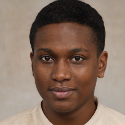 Joyful black young-adult male with short  brown hair and brown eyes