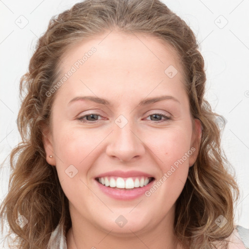 Joyful white young-adult female with long  brown hair and blue eyes