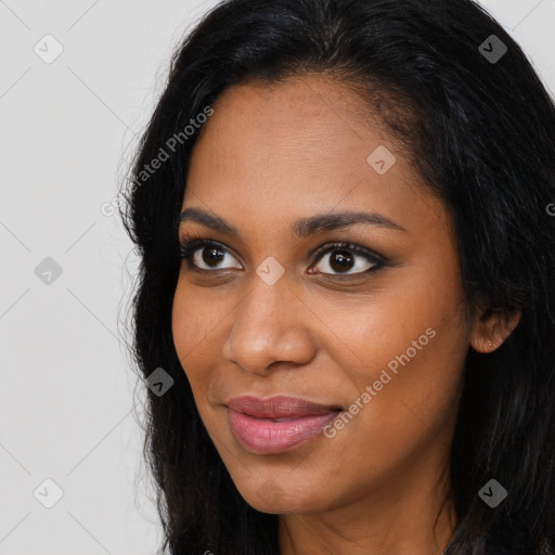 Joyful black young-adult female with long  brown hair and brown eyes