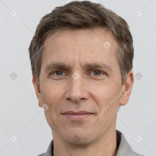 Joyful white adult male with short  brown hair and grey eyes