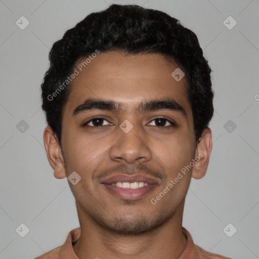 Joyful latino young-adult male with short  black hair and brown eyes