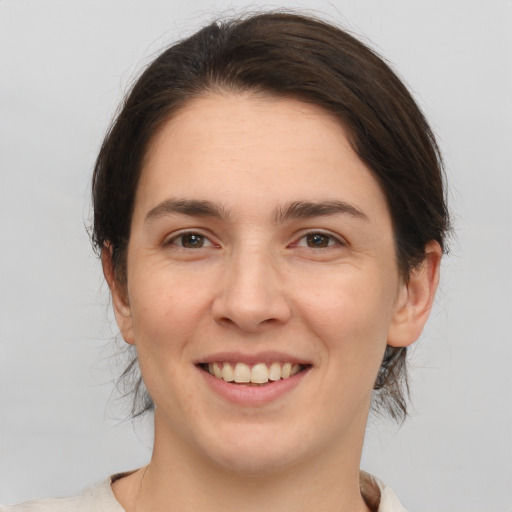 Joyful white young-adult female with medium  brown hair and brown eyes