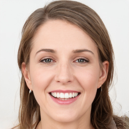 Joyful white young-adult female with long  brown hair and grey eyes