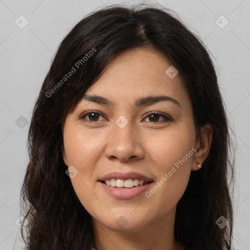 Joyful latino young-adult female with long  brown hair and brown eyes