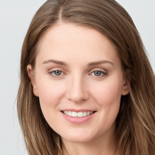 Joyful white young-adult female with long  brown hair and grey eyes