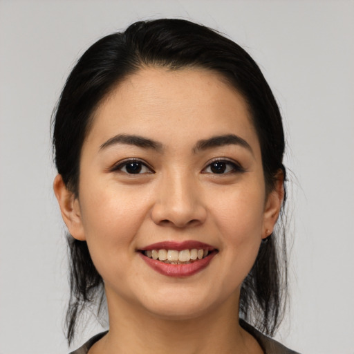 Joyful asian young-adult female with medium  black hair and brown eyes