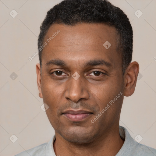 Joyful black adult male with short  black hair and brown eyes