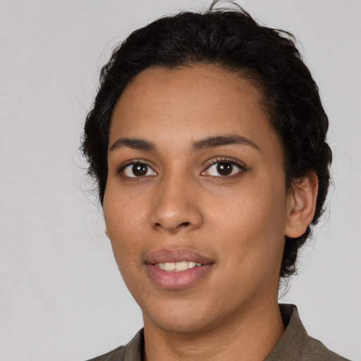 Joyful latino young-adult female with short  black hair and brown eyes
