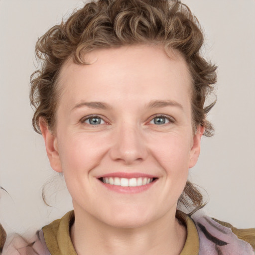 Joyful white young-adult female with medium  brown hair and blue eyes