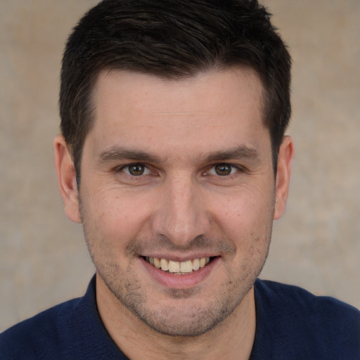 Joyful white adult male with short  brown hair and brown eyes