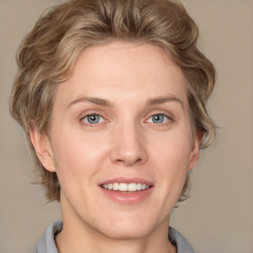 Joyful white young-adult female with medium  brown hair and blue eyes