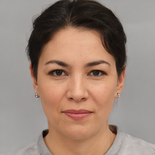 Joyful asian adult female with short  brown hair and brown eyes