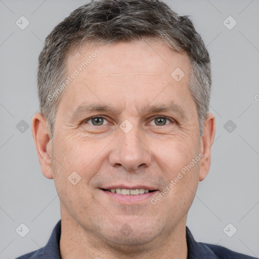 Joyful white adult male with short  brown hair and brown eyes