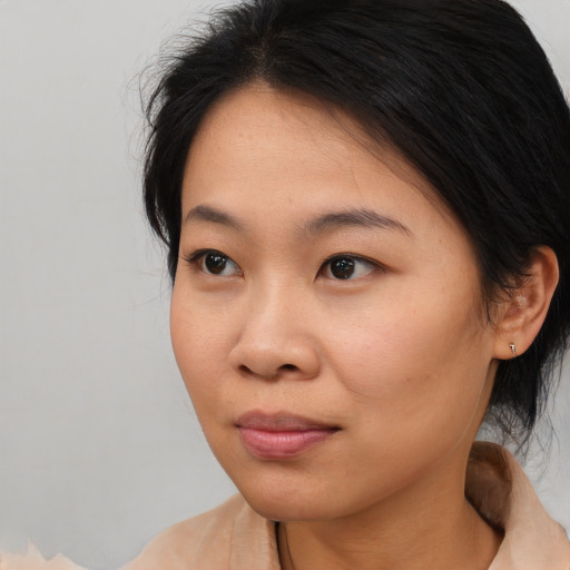 Joyful asian young-adult female with medium  brown hair and brown eyes