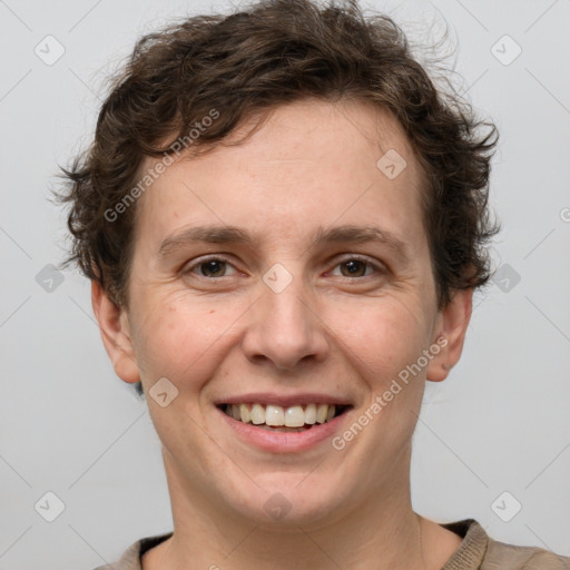 Joyful white adult male with short  brown hair and grey eyes