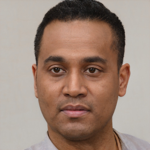 Neutral latino young-adult male with short  black hair and brown eyes