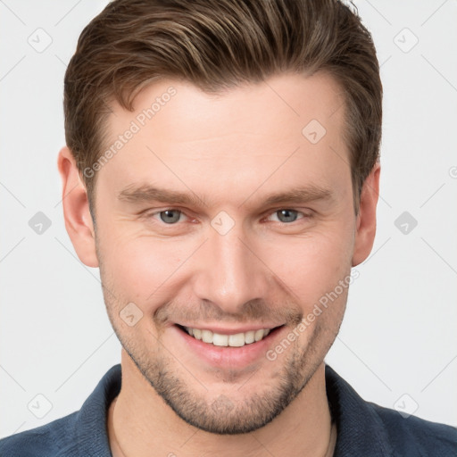 Joyful white young-adult male with short  brown hair and grey eyes