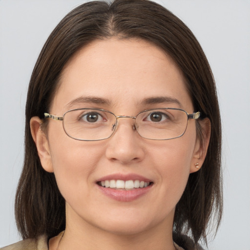 Joyful white young-adult female with medium  brown hair and brown eyes