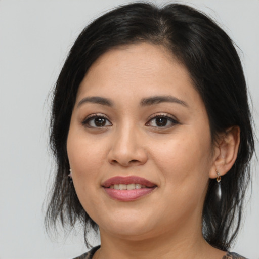 Joyful asian young-adult female with medium  brown hair and brown eyes