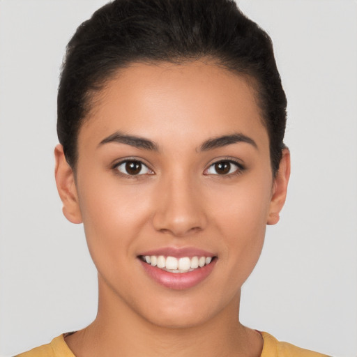 Joyful latino young-adult female with short  brown hair and brown eyes