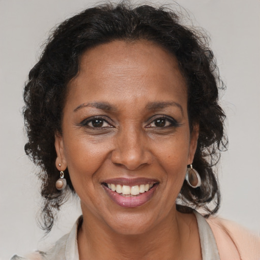 Joyful black adult female with medium  brown hair and brown eyes